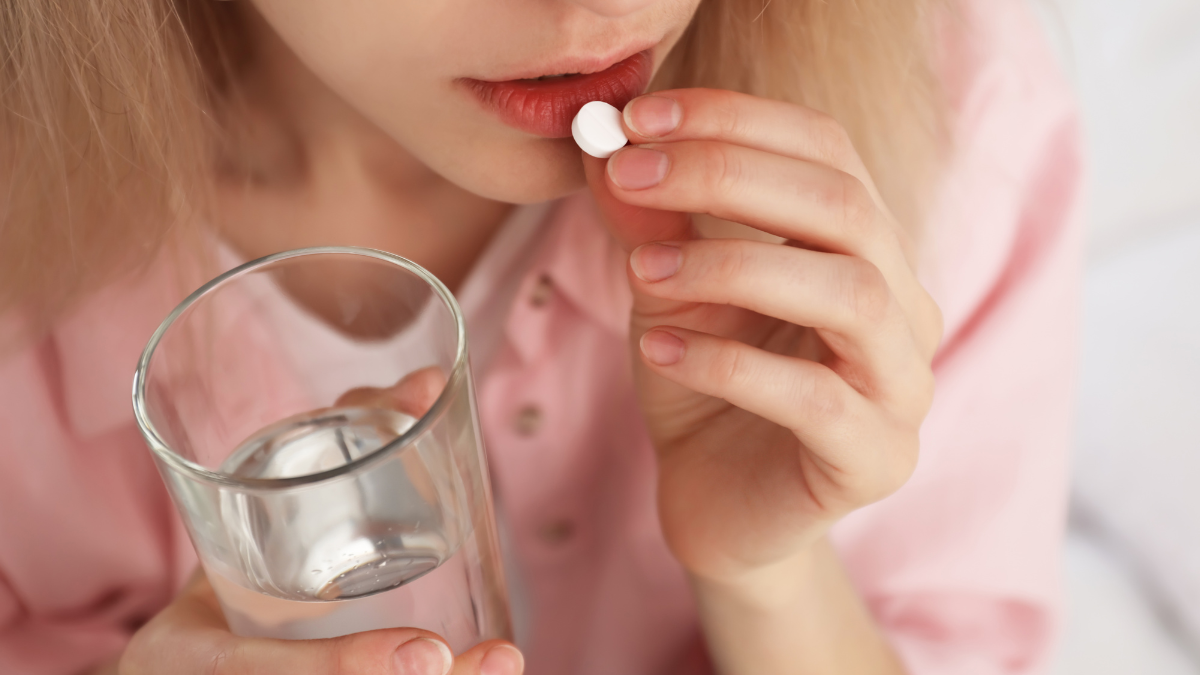 woman taking pill