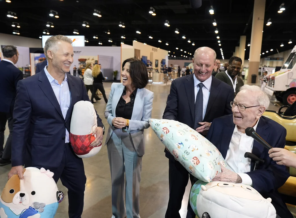 Jazwares CEO Judd Zebersky and president Laura Zebersky greets Greg Abel, Berkshire Hathaway Vice Chairman and Warren Buffett, Chairman and CEO of Berkshire Hathaway with the Squish Pillow that was revealed at the 2025 Berkshire Hathaway Annual Shareholders Festival at the CHI Health Center on Friday, May 2, 2025 in Omaha, Neb.