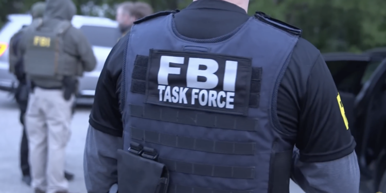 man wearing FBI tactical vest