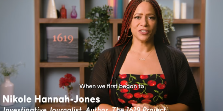 Nikole Hannah-Jones wearing a cherry dress speaking to the camera