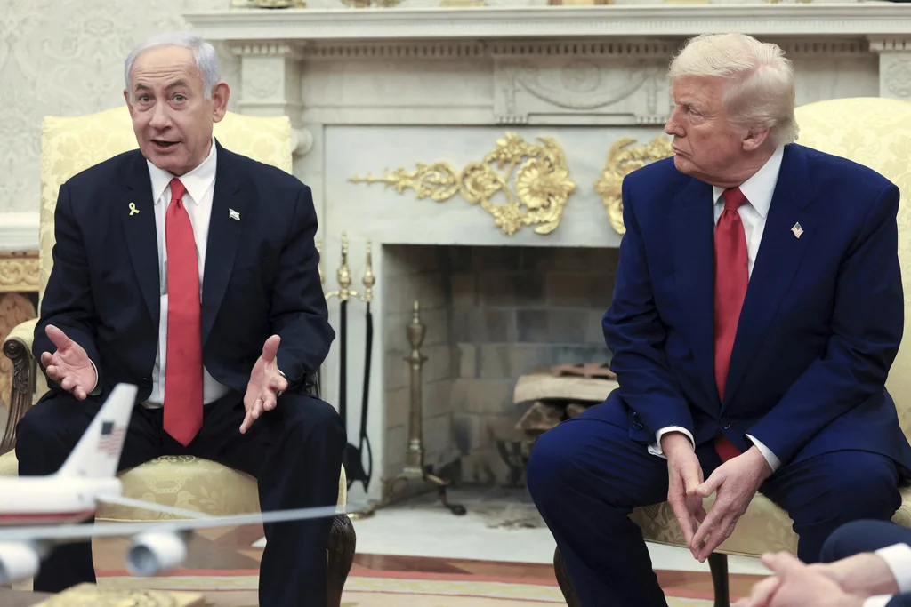 President Donald Trump, right, listens as Israel's Prime Minister Benjamin Netanyahu speaks during a meeting in the Oval Office at the White House in Washington, April 7, 2025.