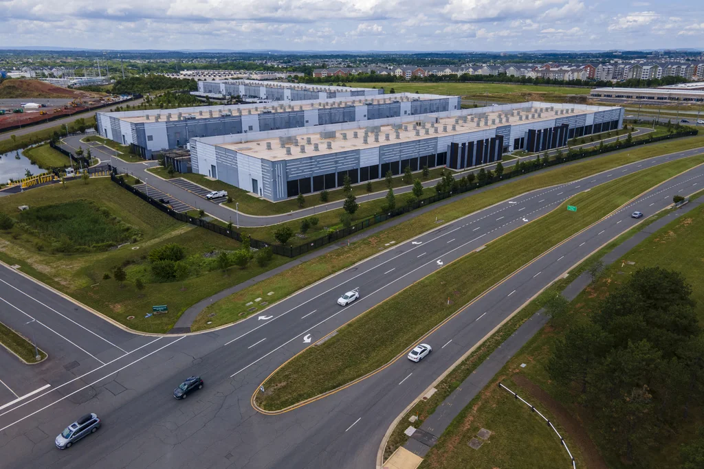 Data centers are in Ashburn in Loudon County, Virginia, on Sunday, July 16, 2023. The centers house the computer servers and hardware required to support modern internet use, including artificial intelligence. The county is home to the world's largest concentration of data centers. Tech companies like to place the centers here, partly because the region's proximity to the nation's traditional internet backbone allows the servers in those data centers to save nanoseconds crucial to support financial transactions, gaming technology and other time-sensitive applications.
