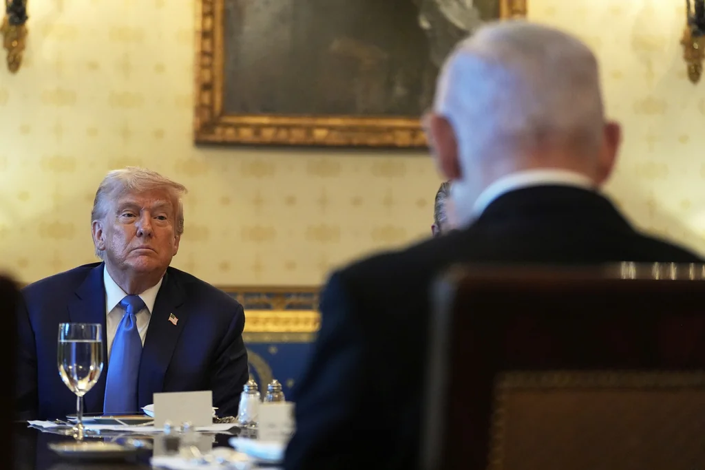 President Donald Trump listens during a meeting with Israel's Prime Minister Benjamin Netanyahu, right, in the Blue Room of the White House, Monday, July 7, 2025, in Washington. 