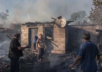 Ukrainian civilians try to extinguish a house fire after Russian shelling on the city of Kostiantynivka, Ukraine, 16 July 2025. (Photo by Diego Herrera Carcedo/Anadolu via Getty Images)