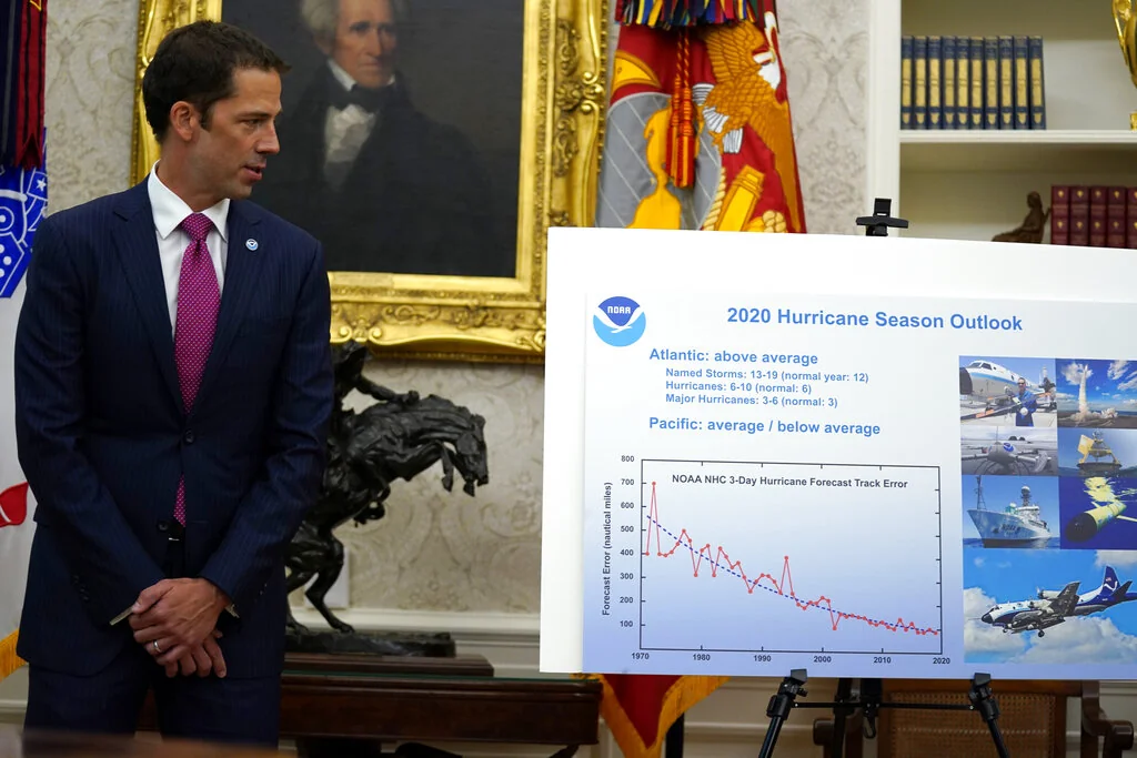 Neil Jacobs, assistant Secretary of Commerce for Environmental Observation and Prediction, listens during a briefing with President Donald Trump on the 2020 hurricane season in the Oval Office of the White House, Thursday, May 28, 2020, in Washington. (AP Photo/Evan Vucci)