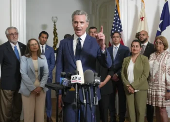Accompanied by California and Texas lawmakers, California Gov. Gavin Newsom, center, discusses the push to schedule a special election to redraw California