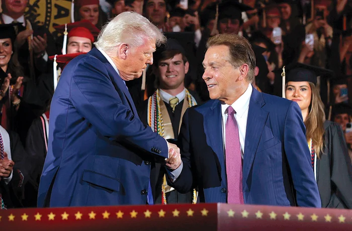 President Donald Trump shakes hands with former Alabama football coach Nick Saban, May 1, 2025, in Tuscaloosa, Alabama. Trump created a presidential commission on college sports, of which Saban and billionaire Texas Tech booster Cody Campbell are members. (Anna Moneymaker/Getty Images)