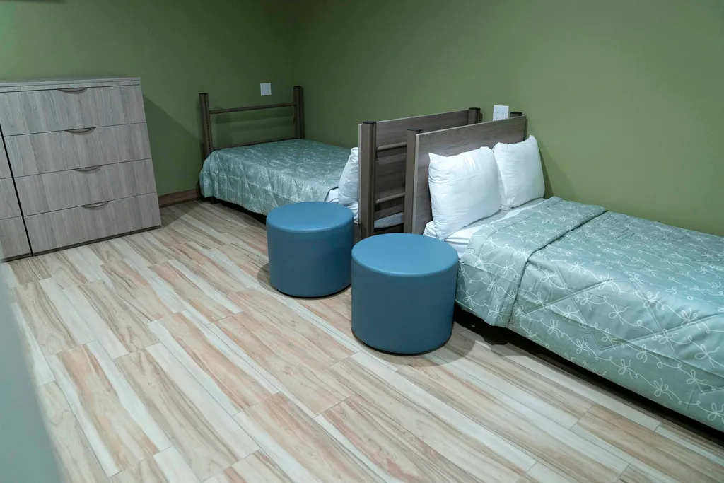 A bedroom is seen at the opening of a new housing shelter for homeless adults in Washington, Thursday, August. 21, 2025. (AP Photo/Jose Luis Magana)
