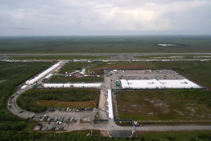 Work progresses on a new migrant detention facility dubbed "Alligator Alcatraz," at Dade-Collier Training and Transition facility in the Florida Everglades, on July 4, 2025, in Ochopee, Florida. (AP Photo/Rebecca Blackwell, File)
