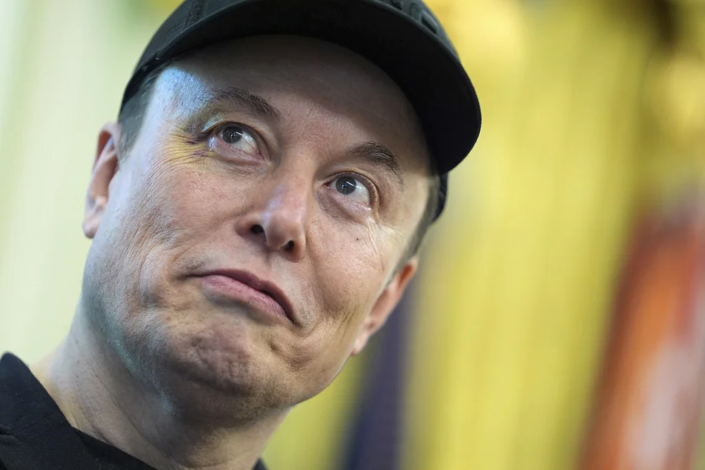 Elon Musk listens as President Donald Trump speaks during a news conference in the Oval Office of the White House, Friday, May 30, 2025, in Washington.