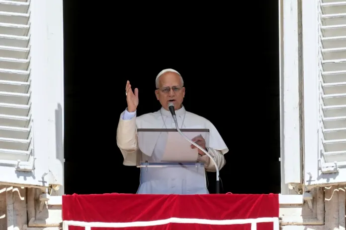 Pope Leo XIV delivers his blessing as he recites the Angelus noon prayer from the window of his studio overlooking St.Peter's Square, at the Vatican, Sunday, Aug. 31, 2025. 