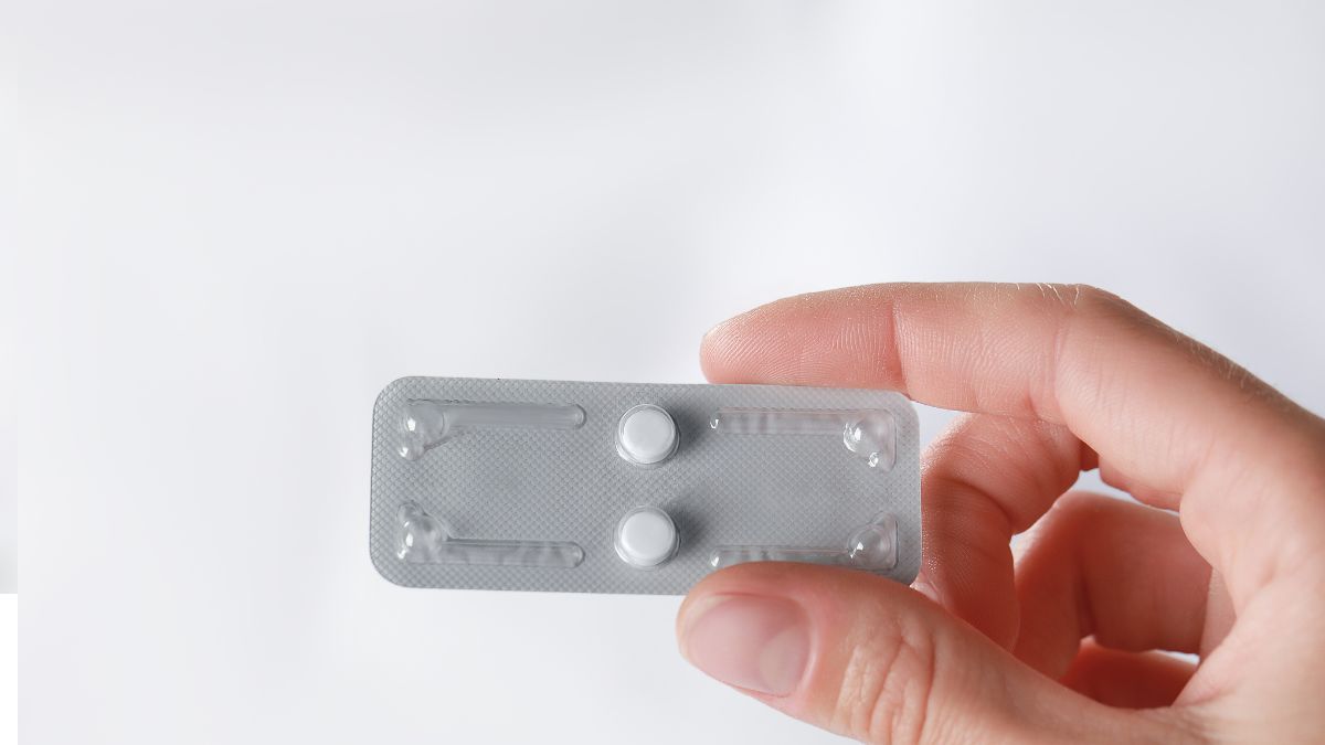 Hand holding pills