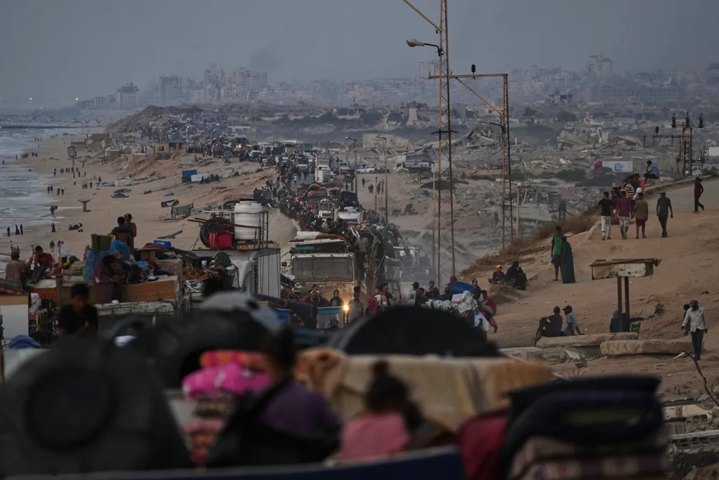 Displaced Palestinians flee Gaza City by foot and vehicles.