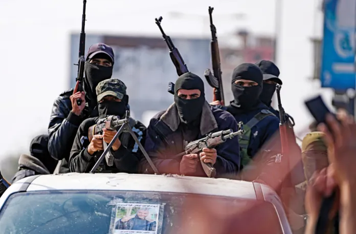 Armed members of Hamas’s Izzedine al-Qassam Brigades on parade in Gaza, Jan. 19, 2025. (Abdel Kareem Hana/AP)