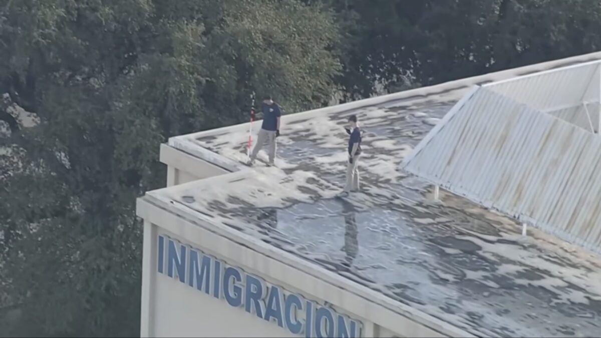 Authorities inspect the rooftop where the Dallas gunman fired on ICE authorities.