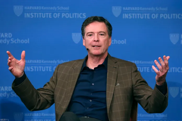 FILE - Former FBI director James Comey gestures while speaking at Harvard University's Institute of Politics' JFK Jr. Forum in Cambridge, Mass., Feb. 24, 2020.