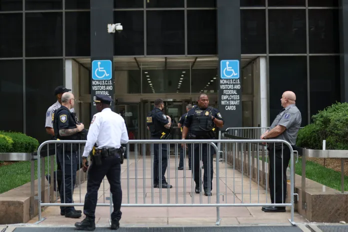 Law enforcement stands outside of 26 Federal Plaza, where immigration court is located, Sunday, June 8, 2025, in New York. 