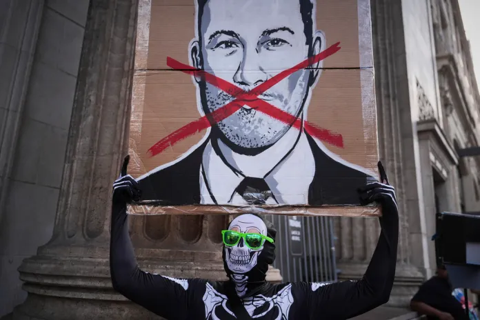 Asher Rogers holds an image of Jimmy Kimmel outside El Capitan Entertainment Centre, where the late-night show "Jimmy Kimmel Live!" is staged on Thursday, Sept. 18, 2025, in Los Angeles.