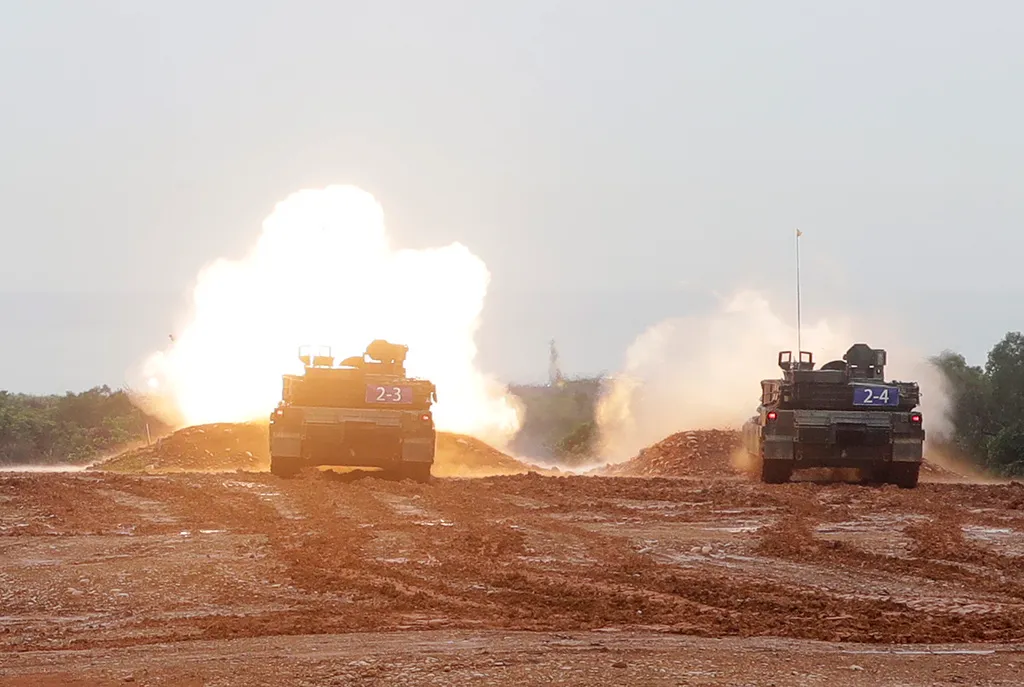 M1A2T Abrams Main Battle Tanks fire during a military live-fire shooting training.