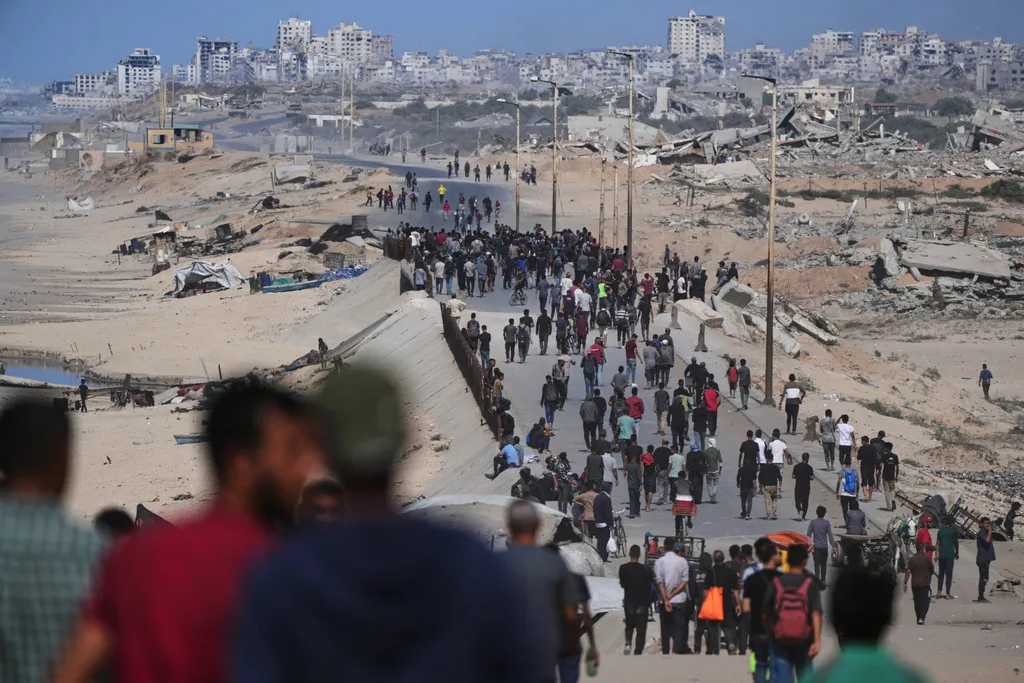 Displaced Palestinians gather on the coastal road near Wadi Gaza.
