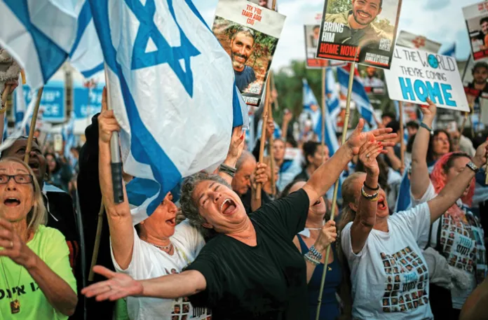 People celebrating hostage releases in Tel Aviv, Oct. 13, 2025. (Emilio Morenatti / AP)