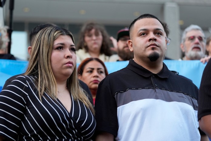 Jennifer Vasquez Sura, left, and her husband, Kilmar Abrego Garcia, attend a protest rally at the Immigration and Customs Enforcement field office in Baltimore, Maryland, Monday, Aug. 25, 2025, to support Abrego Garcia.
