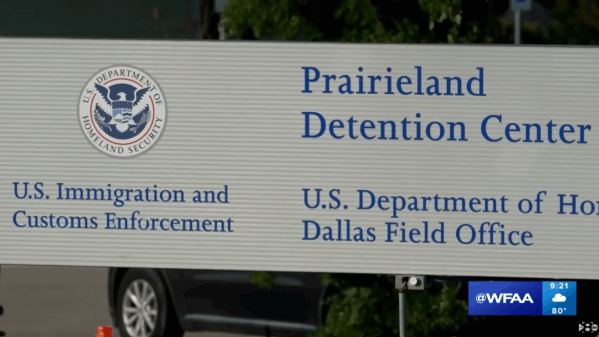 A sign for the Prairieland Detention Center, reading Prairieland Detention Center, U.S. immigration and Customs Enforcement, Dallas Field Office, and cutoff text that begins U.S. Department of Ho .... the image also includes the DHS seal.