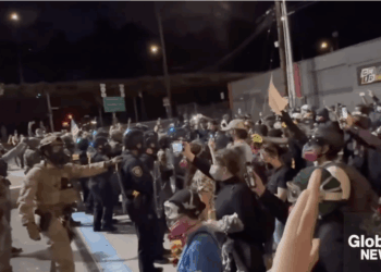 Antifa protesters push against police during a demonstration in Portland.