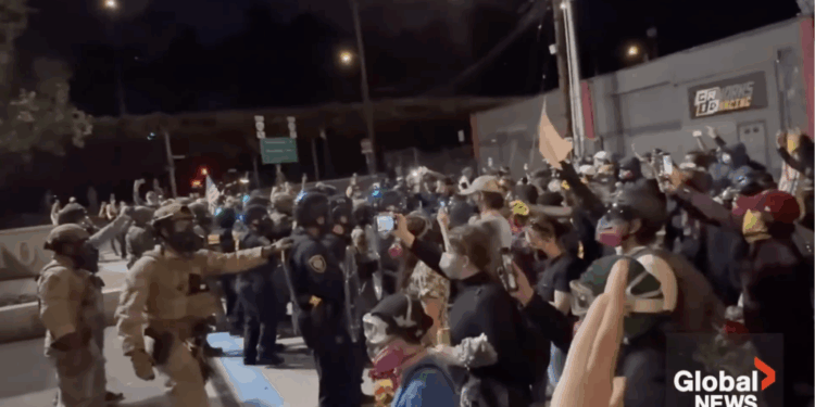 Antifa protesters push against police during a demonstration in Portland.