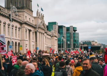 rally outside of building in Ireland with flags