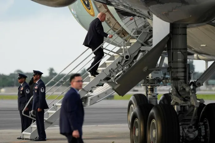 Trump using the small stairs to board Air Force One.