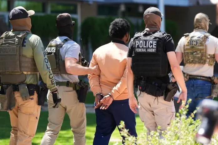 Federal agents takes a person into custody