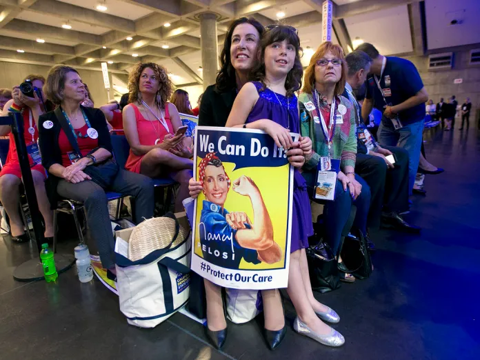 Christine Pelosi holds her daughter Bella Pelosi Kaufman as she listens to her mother, U.S. Rep. Nancy Pelosi, speak.