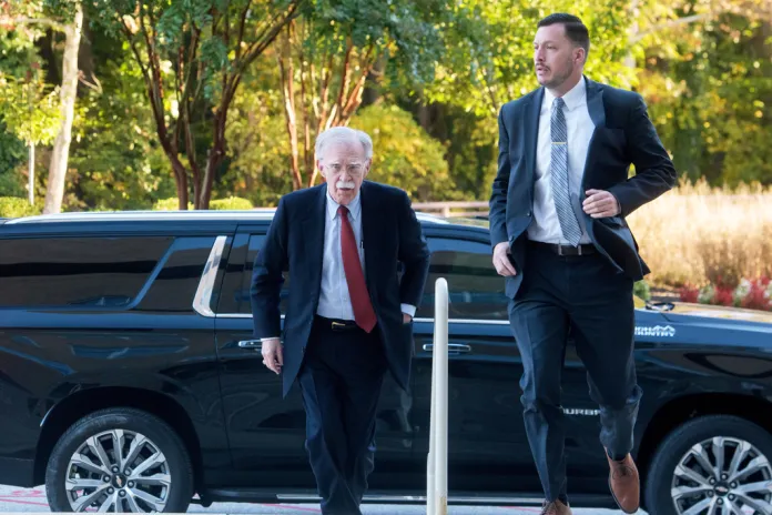 Former Trump administration national security adviser John Bolton, left, arrives for his arraignment at the Greenbelt Federal Courthouse in Greenbelt, Md., Friday, Oct. 17, 2025.