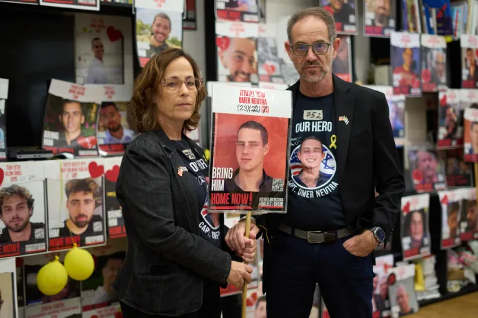 Ronen and Orna Neutra, parents of Omer Neutra, a U.S.-Israeli citizen who was killed in the Hamas-led attacks on Oct. 7, 2023, present a photo of their son in Tel Aviv, Israel, Monday, Oct. 27, 2025.