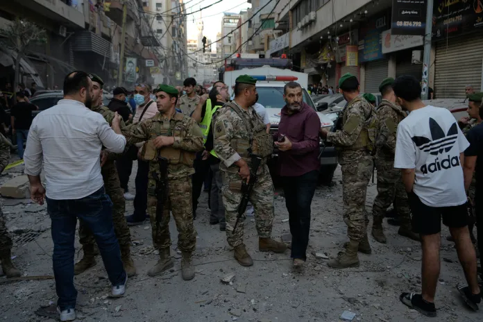 Army soldiers banned people to enter the site where an Israeli strike hit at an apartment on Dahiyeh in the southern suburb of Beirut, Sunday, Nov. 23, 2025. 