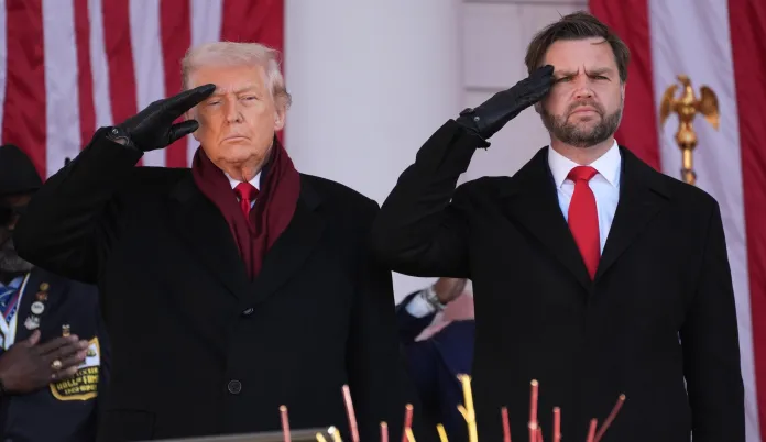 President Donald Trump, with Vice President JD Vance, salutes before speaking during an event to mark Veterans Day at Arlington National Cemetery, Tuesday, Nov. 11, 2025, in Arlington, Va. (AP Photo/Evan Vucci)