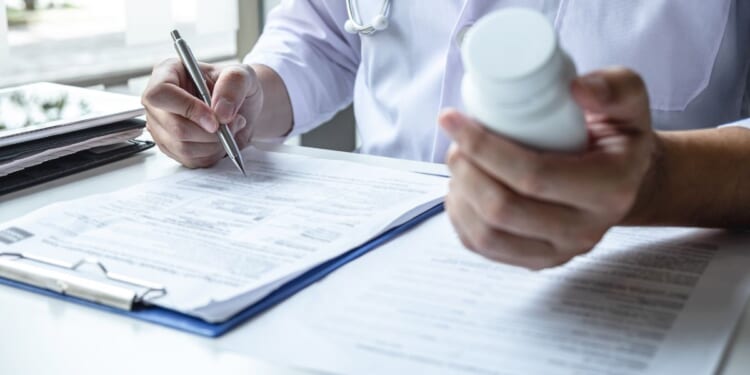 doctor holding pills