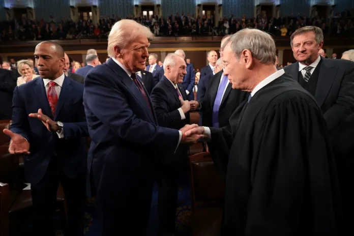 FILE - President Donald Trump, center, greets Chief Justice of the Supreme Court John Roberts, right, as he arrives to address a joint session of Congress at the Capitol in Washington, March 4, 2025. (Win McNamee/Pool Photo via AP, File)