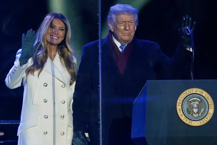 President Donald Trump and first lady Melania Trump wave to supporters after lighting the National Christmas Tree.