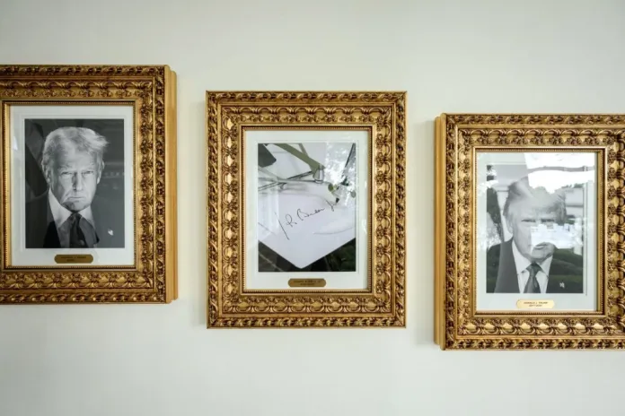 Image of the presidential portraits with President Trump's on the left and right and the image of Biden swapped for an autopen, in the center.
