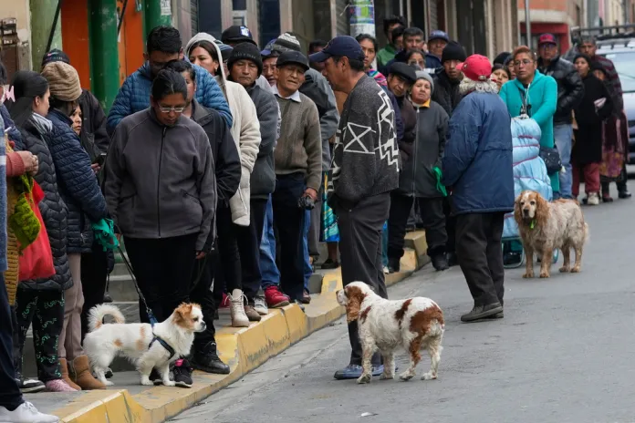 Bolivian citizens wait in bread lines in La Paz