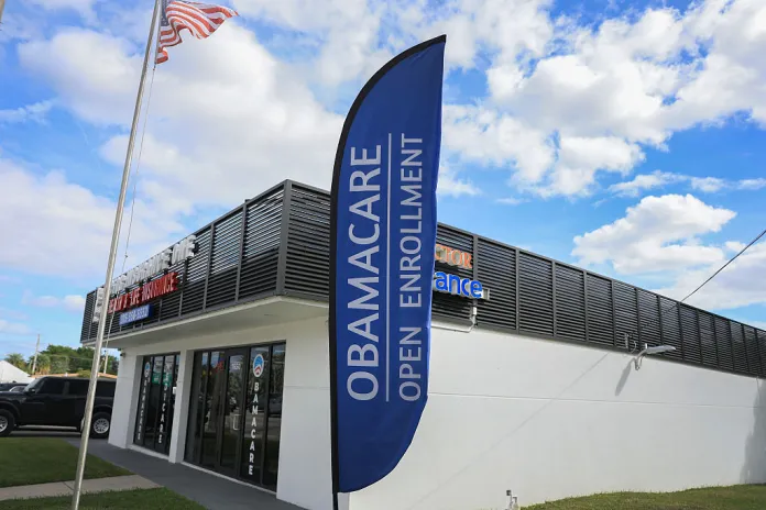 An Obamacare sign sits in front of an insurance agency on November 12, 2025 in Miami, Florida. House Democrats are said to be looking at steps to force a vote on extending the expiring Affordable Care Act tax credits after Republicans did not address the issue as part of a deal to reopen the federal government. The House is expected to vote today on ending the record-long government shutdown. (Joe Raedle/Getty Images)