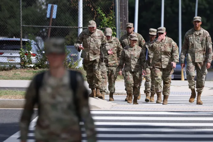 National Guard troops walk across the street.