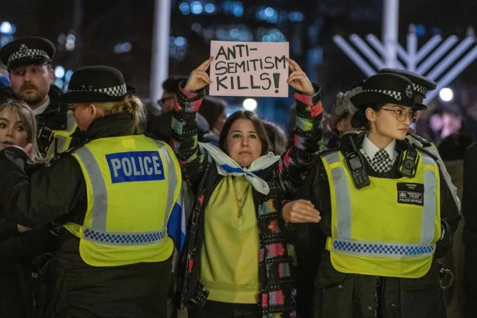 People take part in a vigil at Parliament Square in London, Monday, Dec. 15, 2025 after the Bondi Beach terrorist attack in Sydney. (AP Photo/Thomas Krych)