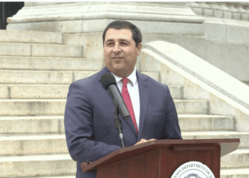 Wisconsin Attorney General Josh Kaul holds a press conference on the state capitol steps.