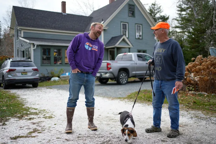 Graham Platner, Democratic candidate for U.S. Senate, chats with his neighbor, Denis Nault, Monday, Nov. 3, 2025, in Sullivan, Maine