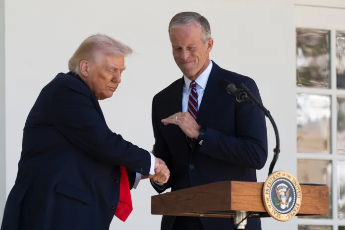 President Donald Trump shakes hands with Senate Majority Leader John Thune, R-S.D., right, during a lunch with Republican Senators on the Rose Garden patio at the White House, Tuesday, Oct. 21, 2025, in Washington