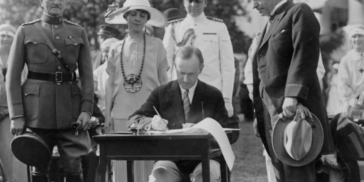 Calvin Coolidge signing legislation