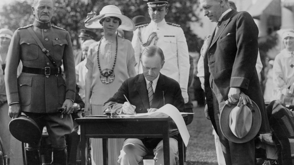 Calvin Coolidge signing legislation